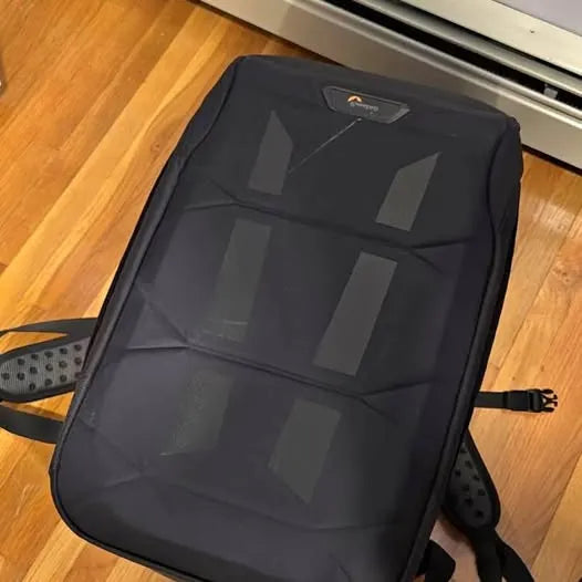 Drone backpack with padded front panel and black shoulder straps
