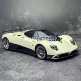 Light yellow 1:18 diecast sports car model, front three-quarter view, detailed wheels.