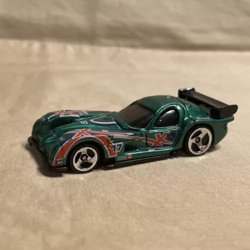 Green Hot Wheels diecast race car with white-red decals, black spoiler, detailed wheels