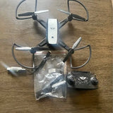 White beginner quadcopter drone with remote controller and spare parts bag