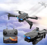 Foldable quad drone with dual camera, black body, blue LEDs and remote controller