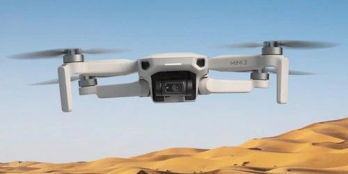 DJI Mavic Mini 2 drone with camera and four propellers, light gray body
