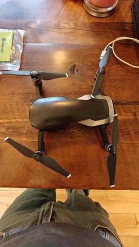 DJI Mavic Air drone with propellers and front gimbal, folding arms