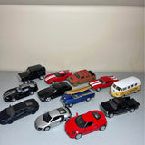 Diecast car collection with black, red, blue, silver, white and yellow vehicles