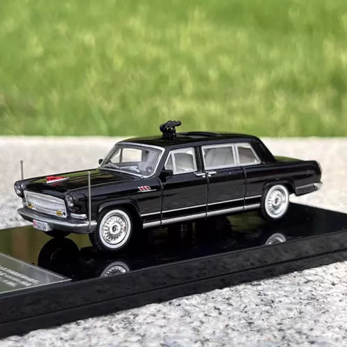 Black diecast sedan model with silver wheels, side and front view