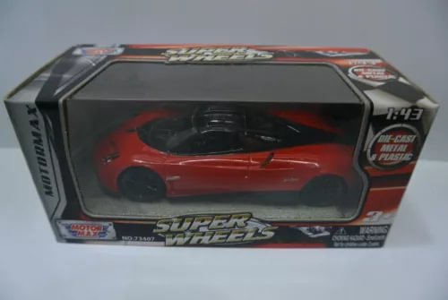 Red die-cast sports car model in retail display box with clear window