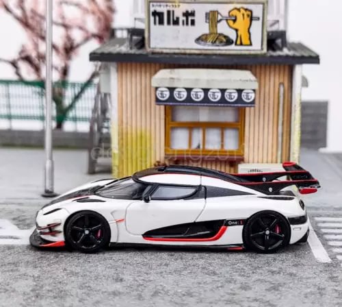 White sports model diecast car with black wheels and red stripe accents