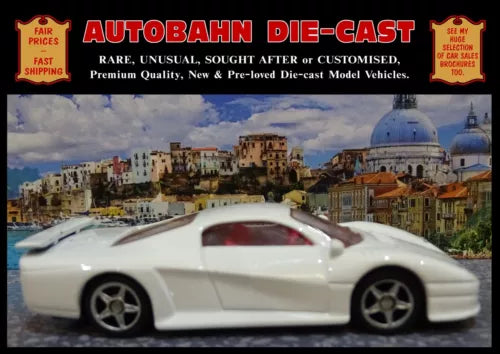 White diecast sports car model, 1:61 scale, side view with silver wheels
