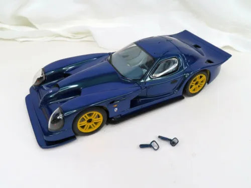 Blue 1:18 diecast sports car model with yellow wheels, front three-quarter view.