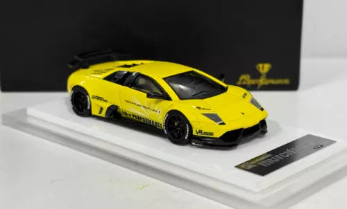 Yellow diecast sports car model with black wheels, on white display base