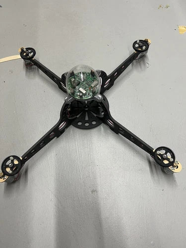 Vintage quadcopter drone with black X-frame and four prop arms