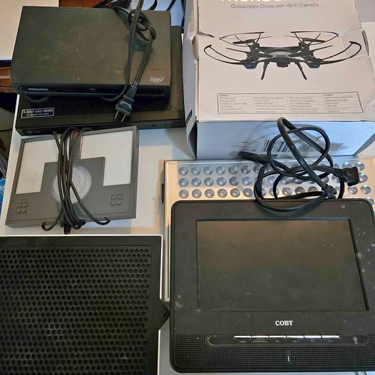 Untested electronics lot with portable screen, cables, and drone accessory