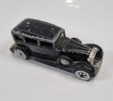 Black Hot Wheels diecast car, classic sedan body with chrome details and wheels