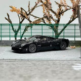 Black diecast sports car model toy with detailed wheels