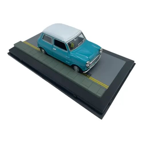 Teal Austin Mini Cooper diecast car (1:43 scale) on dark display base