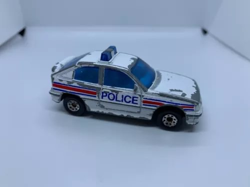 Silver diecast police car with blue hood and red stripe, 1:64 scale, used condition