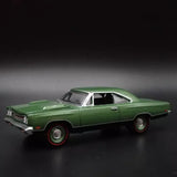 Green 1:64 diecast model car, side view with white roof and stripe