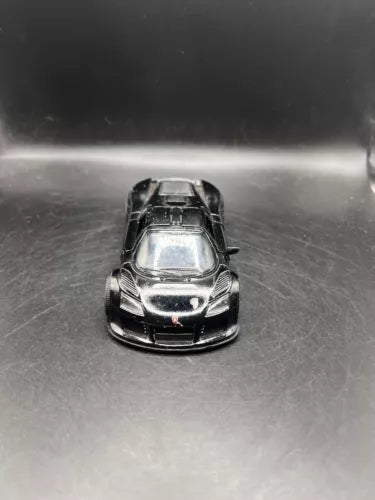 Black diecast toy race car, front view, open wheels detail, 1:36 scale