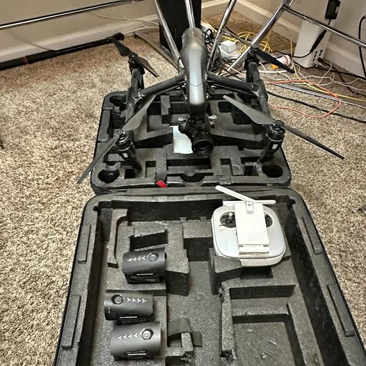 Black drone with gimbal and controller in hard case