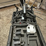 Black drone with gimbal and controller in hard case