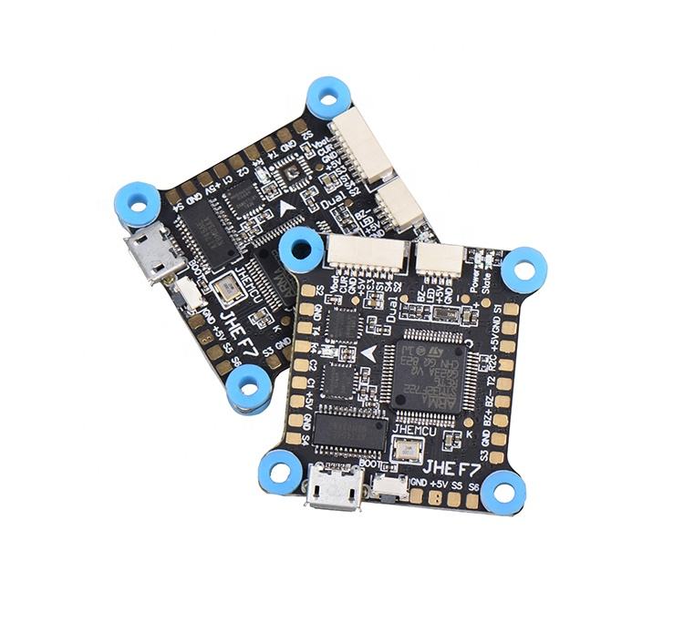 FPV flight controller circuit board with blue mounting holes and small ports