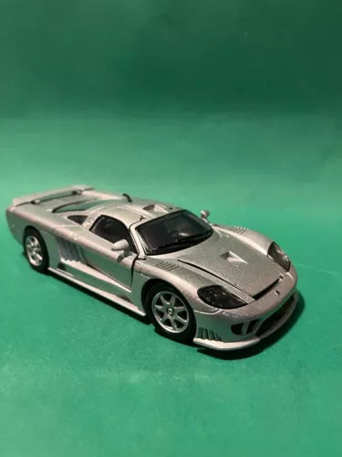 1:24 scale diecast sports car with silver body and black hood