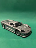 1:24 scale diecast sports car with silver body and black hood