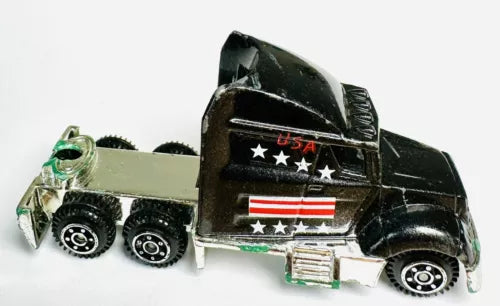 Black diecast semi tractor truck with USA stars and stripes panel on cab