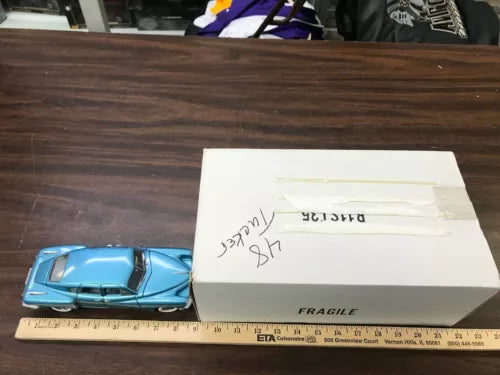 Blue 1:24 scale diecast car model, with box and packing.