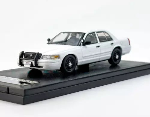 White police diecast toy car, front three-quarter view