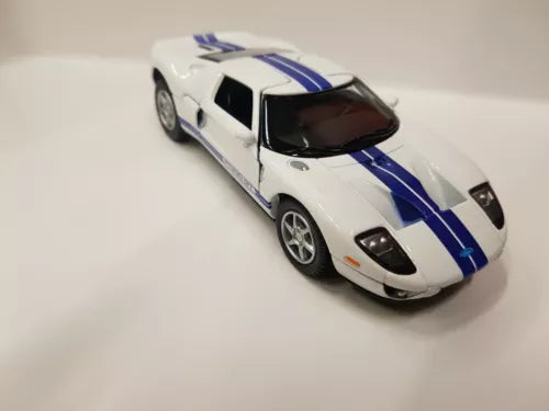 White diecast toy sports car with blue racing stripes, side view