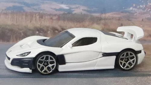 White 1:64 diecast sports car with black accents and silver wheels