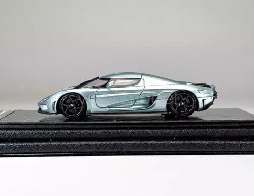 Ice blue sports car model diecast resin, side view with black wheels and accents