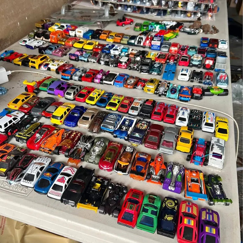 Assorted diecast toy cars in a display tray, mixed colors and styles