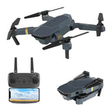Mini quadcopter drone with dark gray body and handheld controller with screen
