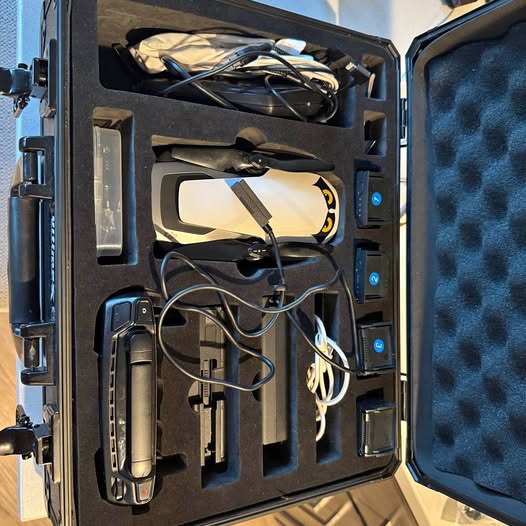Portable drone carry case with drone, controller, and batteries, open
