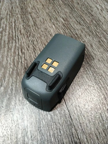 DJI Spark drone battery pack with visible charging contacts, dark gray