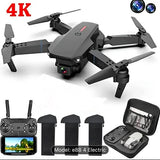 Black mini quadcopter drone with foldable propellers, controller, and carrying case