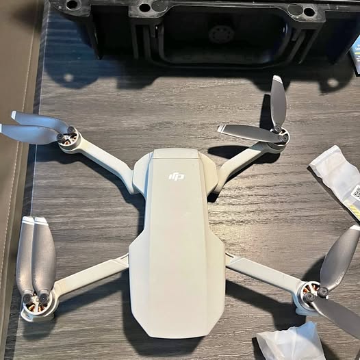 DJI Mavic Mini drone with four white propellers and front camera