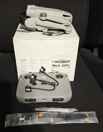 Gray foldable drone kit with controller and accessories in box