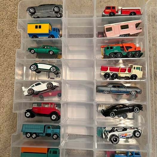 Diecast car set with clear compartment case, assorted cars and trucks
