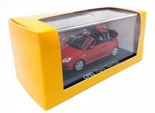 Red 1:43 diecast model car of Opel Tigra Twintop in yellow display box