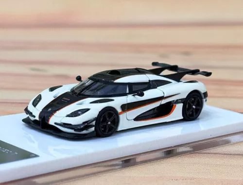 Diecast model supercar with white body, black accents, on display base
