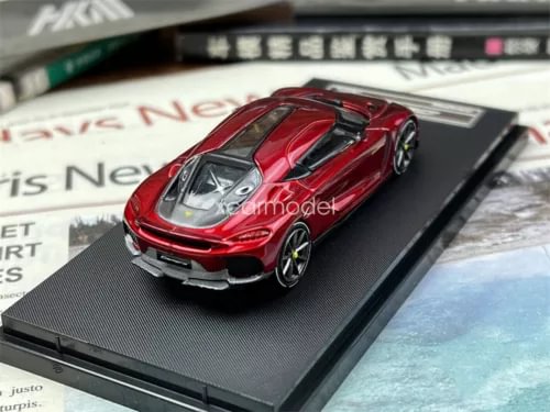 Red diecast sports car model toy on dark display base, detailed front view