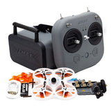 FPV drone kit with gray controller, white quadcopter, antennas and goggles