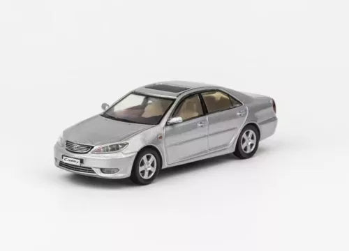 Silver diecast sedan model car with four doors and detailed front lights