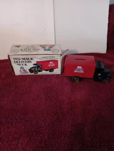 Red 1:38 diecast delivery truck with black cab, shown beside its packaging box