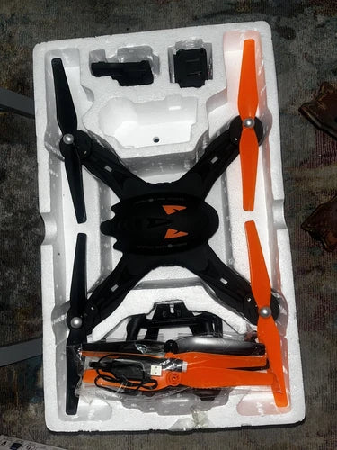 Black and orange Wi‑Fi HD drone with orange propellers in white foam case