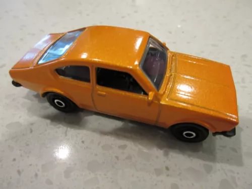 Orange diecast coupe toy car with black wheels and side windows