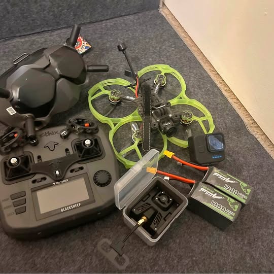 Quadcopter drone with neon green prop guards and remote controller